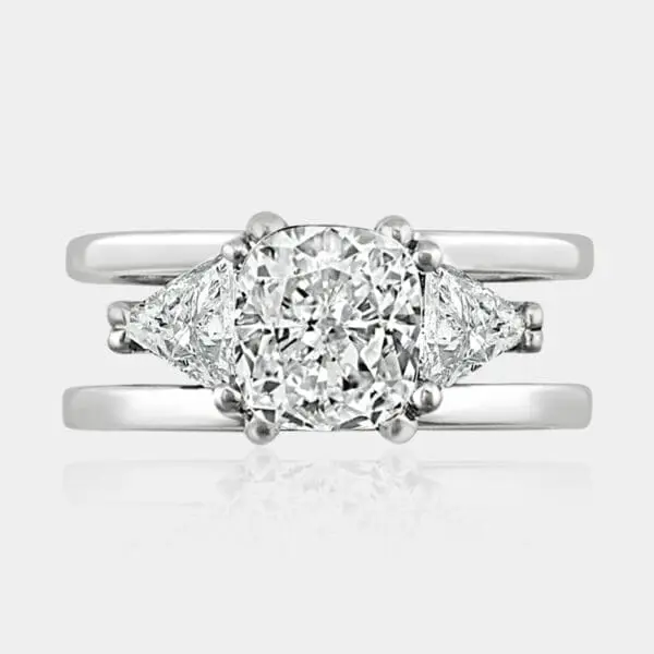 1.60 carat Cushion cut diamond ring with trilliant cut diamonds on each side.