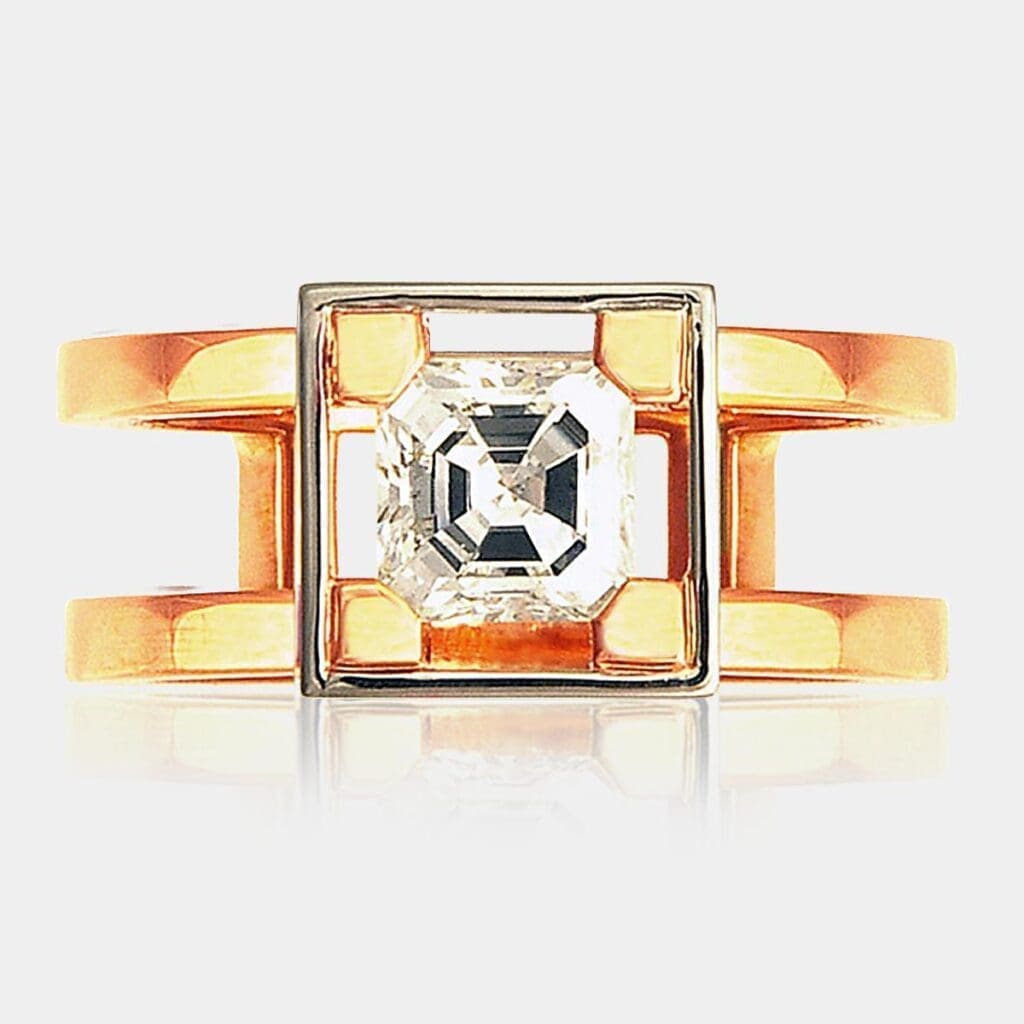 Handmade, contemporary style engagement ring featuring picture-frame set Asscher cut diamond with split band in 18ct rose gold.