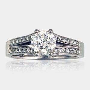 Handmade round brilliant cut diamond engagement ring in18ct white gold, with split shank bead set with round diamonds.