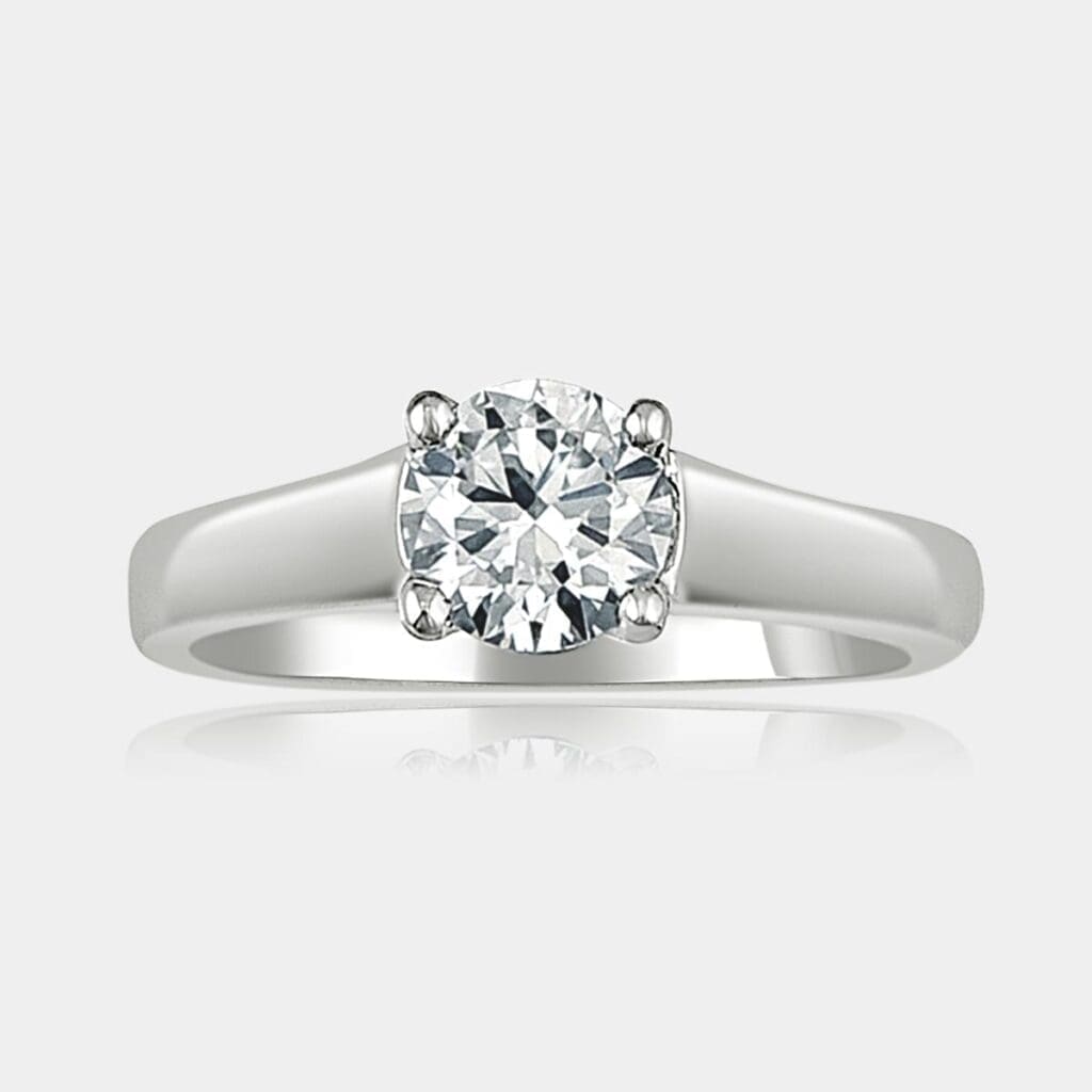 Round brilliant cut solitaire diamond ring in a four claw setting with tapered band.