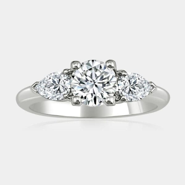3 stone diamond ring featuring round brilliant cut centre diamond and two pear shape diamonds on the side.