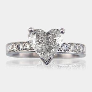 Heart shape diamond engagement ring with a diamonds in the band.