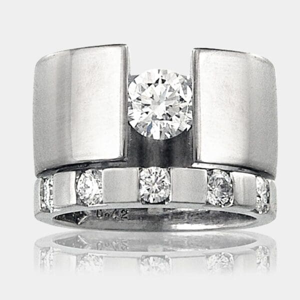 Suspension set 0.62 carat diamond ring in 18ct white gold and matching diamond and white gold wedding band.