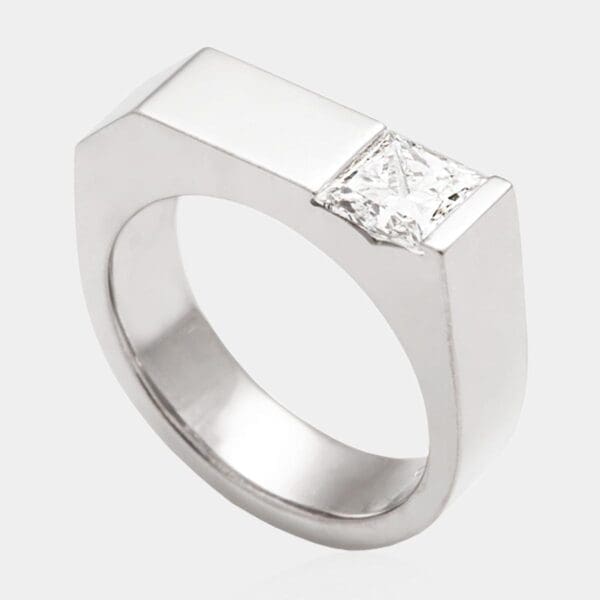 Handmade, contemporary style engagement ring featuring princess cut diamond set in solid 18ct white gold band.