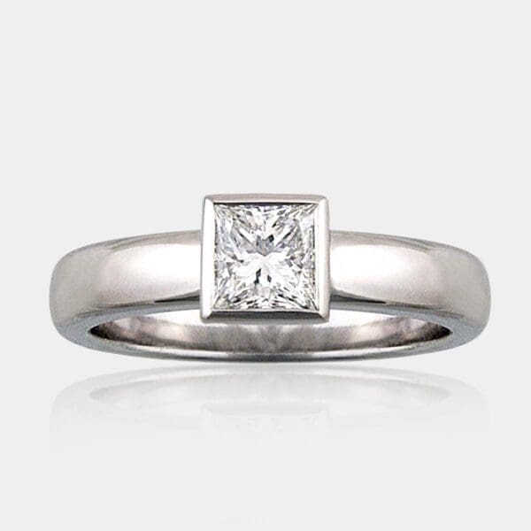 0.80 carat Princess cut solitaire diamond ring with a simple 18ct white gold band.