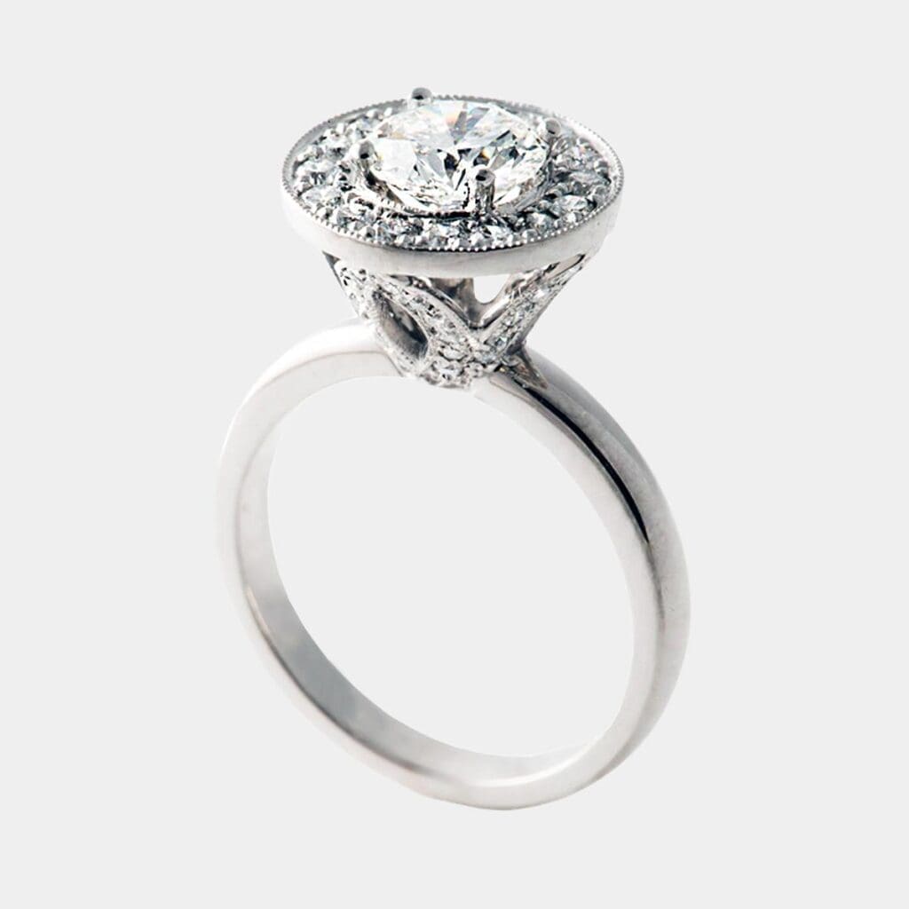 Handmade, vintage style engagement ring with round brilliant cut diamonds, detailed diamond setting and milgrain finish in 18ct white gold.