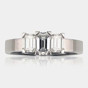 Handmade, three-stone emerald cut diamond engagement ring in 18ct white gold.