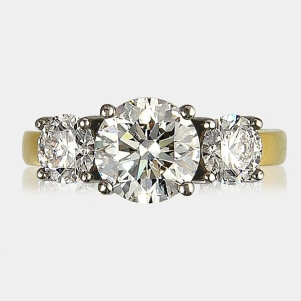 3 stone round brilliant cut diamond ring totaling 2.74 carat, set in 18ct white and yellow gold.