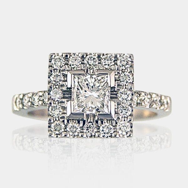 Princess cut diamond ring with round diamond halo surrounding centre stone and round diamonds in the band.