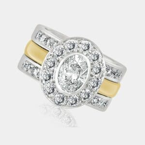 1.20 carat Oval cut diamond halo ring in white and yellow gold, with 2 diamond set wedding bands.
