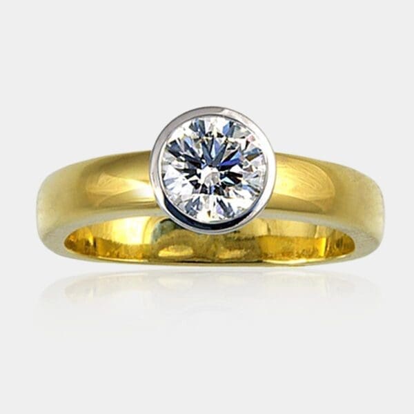 0.85 carat Round bezel set diamond ring in white and yellow gold.