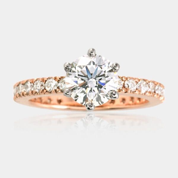 Diamond engagement ring, with white gold six-claw setting and 18ct rose gold band, fully set with round brilliant cut diamonds all the way around.
