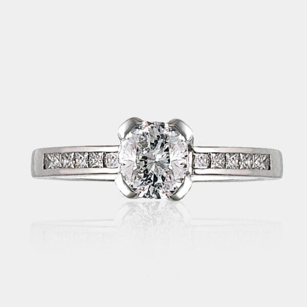 1.10 carat Cushion cut diamond ring with shoulder princess cut diamonds in 18ct white gold.