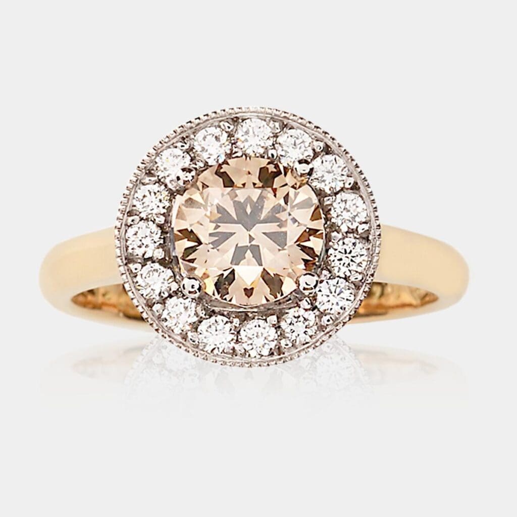 Handmade, champagne diamond engagement ring or fashion ring in 18ct white gold halo setting with round brilliant cut diamonds around the centre stone and fine milgrain detail.
