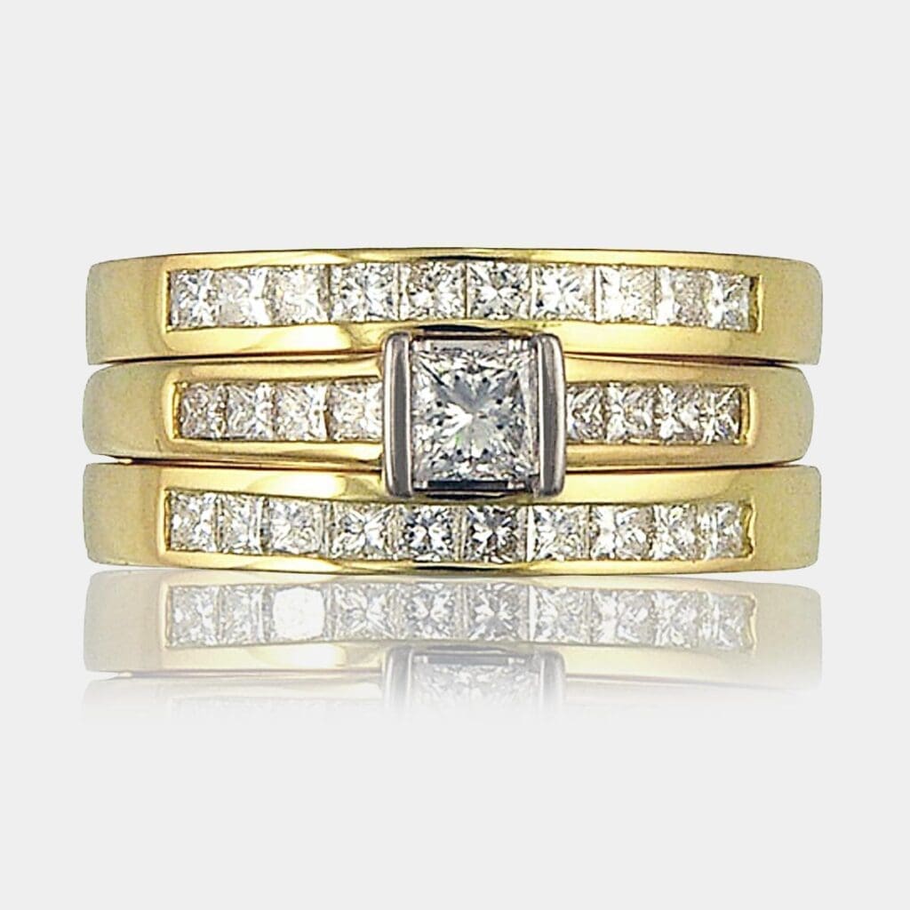 Princess cut diamond engagement ring with shoulder diamonds with 2 matching wedding rings.