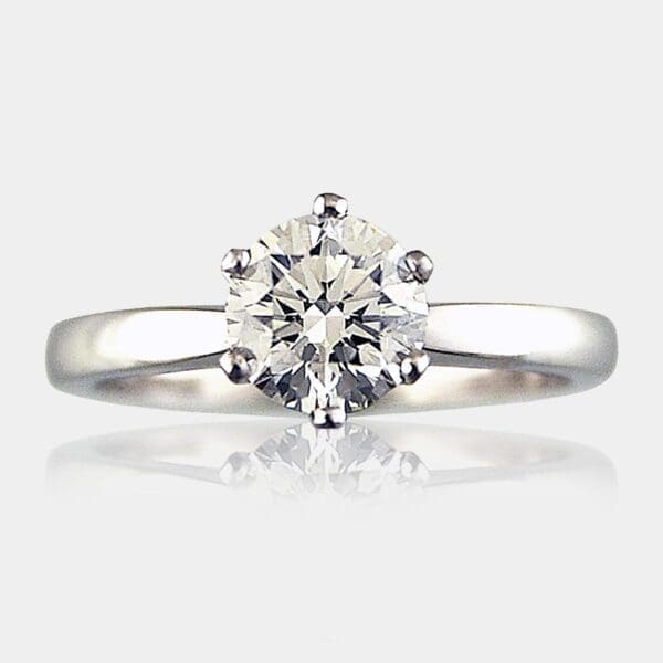 Round brilliant cut diamond engagement ring with 6 claws and slightly rounded band.