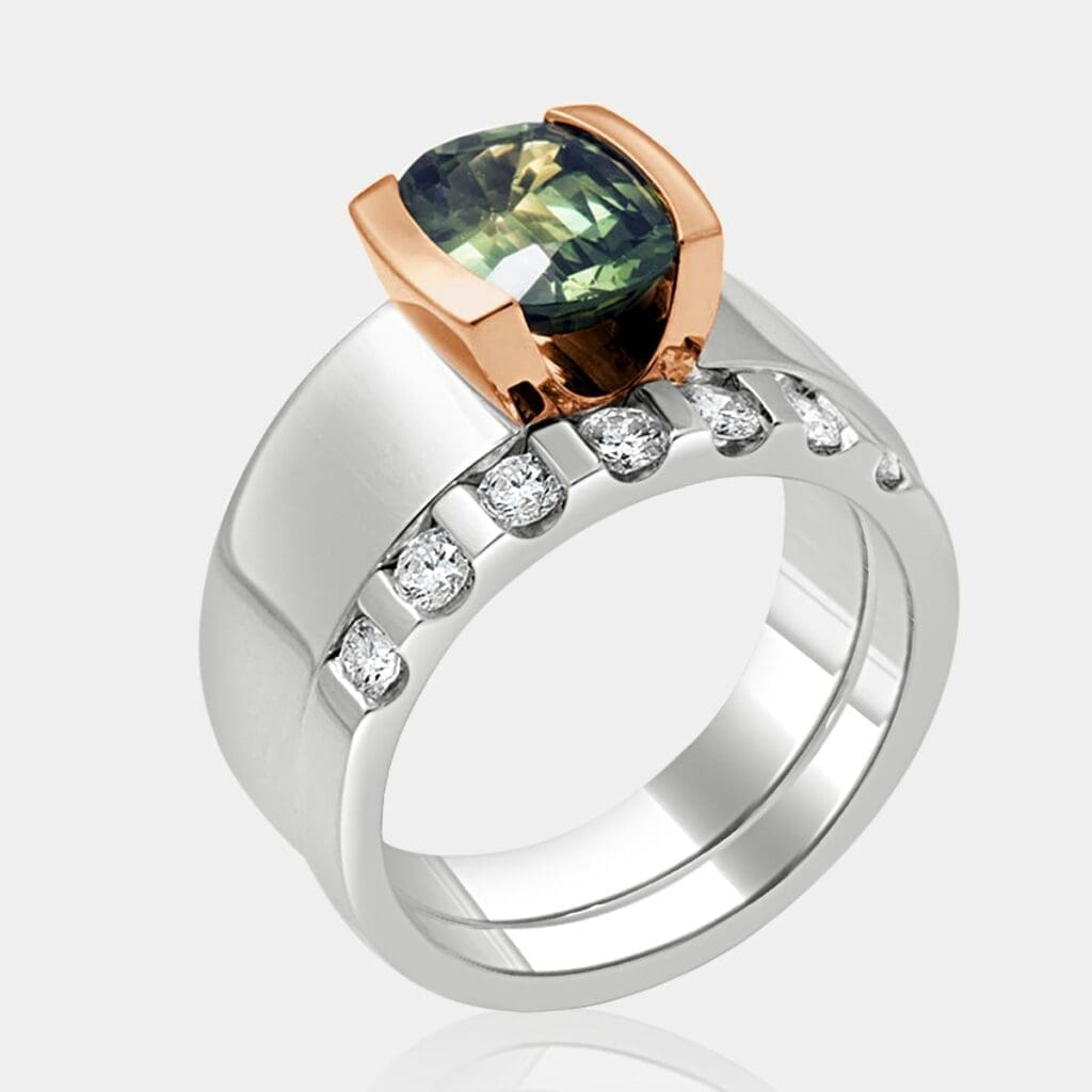 Contemporary, two-tone engagement ring featuring green tourmaline with matching round brilliant cut diamond wedding ring.
