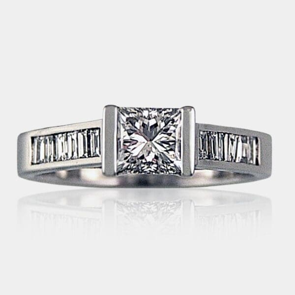 Princess cut diamond engagement ring with channel set baguette diamonds in the band.