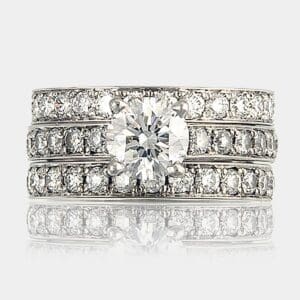 Round brilliant cut engagement ring with diamond bead set wedding and eternity rings.