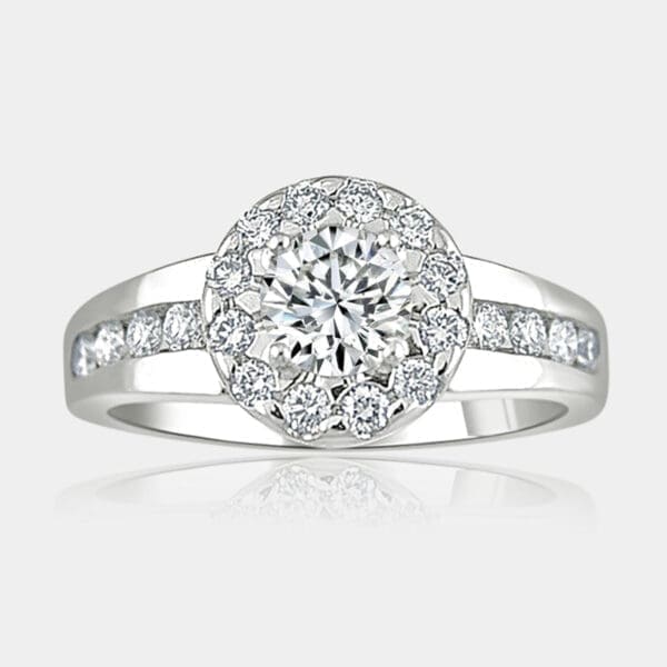 Round brilliant cut cluster diamond engagement ring with tapered band set with diamonds.