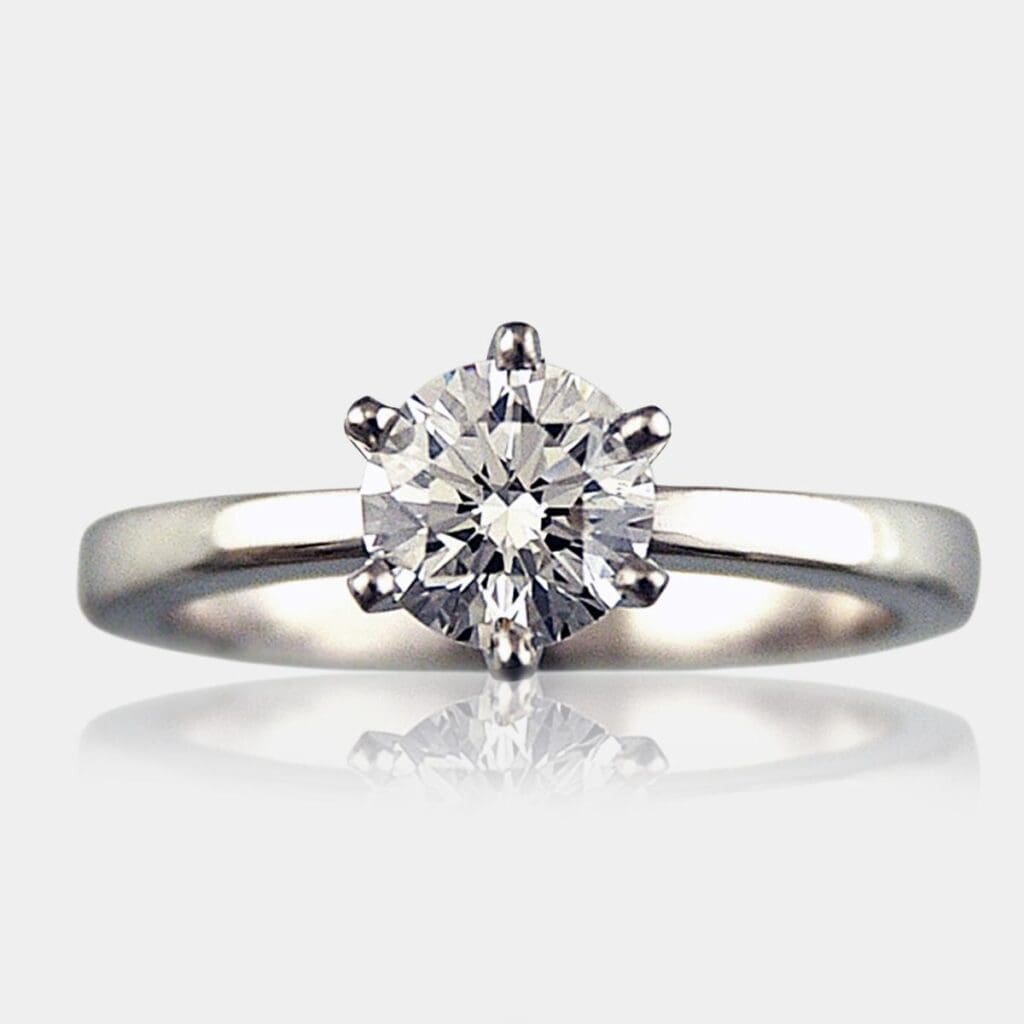 Round brilliant cut engagement ring with rounded white gold band.