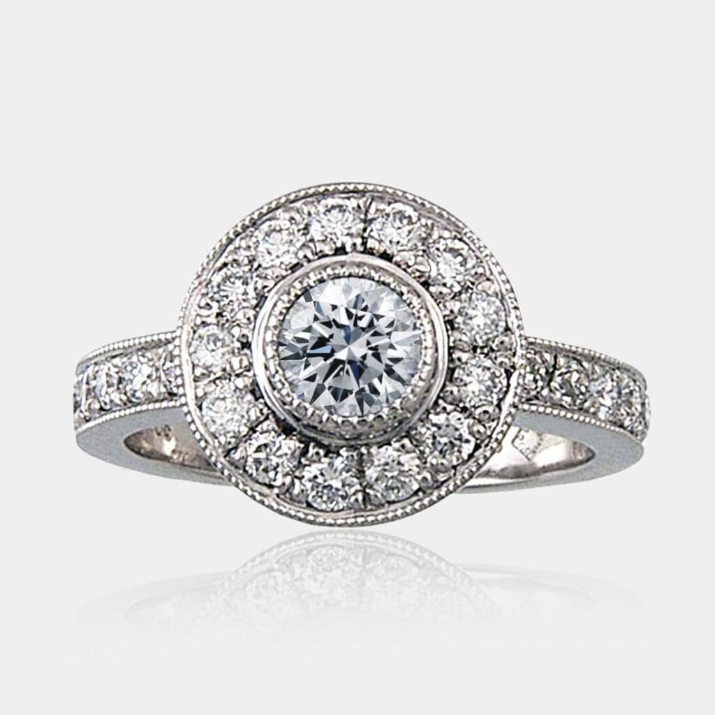 0.45 carat Round brilliant cut diamond halo ring with round shoulder diamonds and milgrain detail.