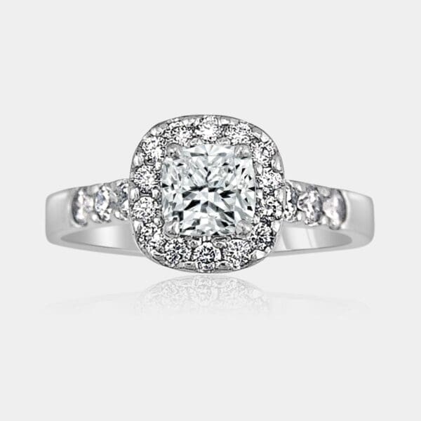Handmade 18ct white gold, cushion cut diamond engagement ring with a halo of round diamonds and diamonds in the band.