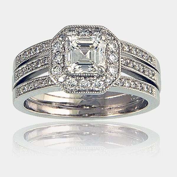 0.84 carat asscher cut diamond centre with surround diamonds and 3 diamond set bands of 18ct white gold.