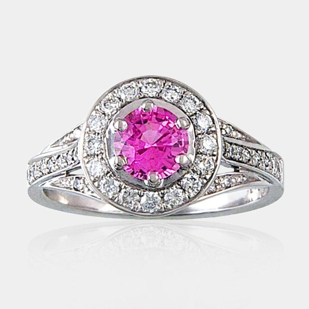 1.00 carat Pink sapphire ring with diamond halo and three row split band bead set with diamonds.