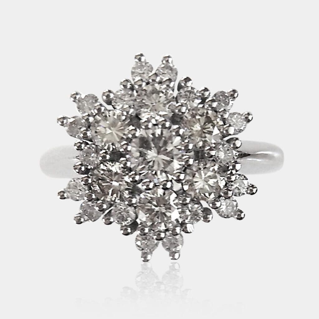 Handmade, cluster style engagement ring or fashion ring with round brilliant cut diamonds surrounding the centre stone, creating a star or flower shape.