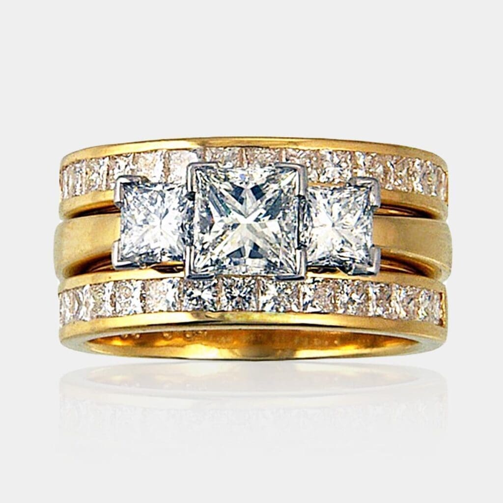3 stone princess cut diamond ring in 18ct white and yellow gold and two matching princess cut diamond wedding rings in 18ct yellow gold.