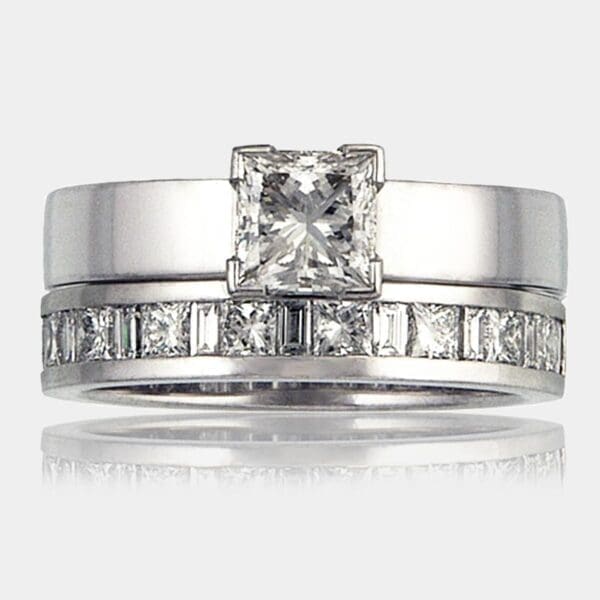 Princess cut engagement ring with 1.1 carat princess cut diamond in 18ct white gold. Matching wedding ring with princess cut and baguette cut diamonds.