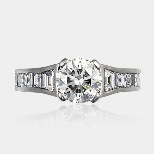 1.20 carat Round diamond brilliant cut with 1.02 carat of trapezoid and carre cut side stones, set in 18ct white gold.