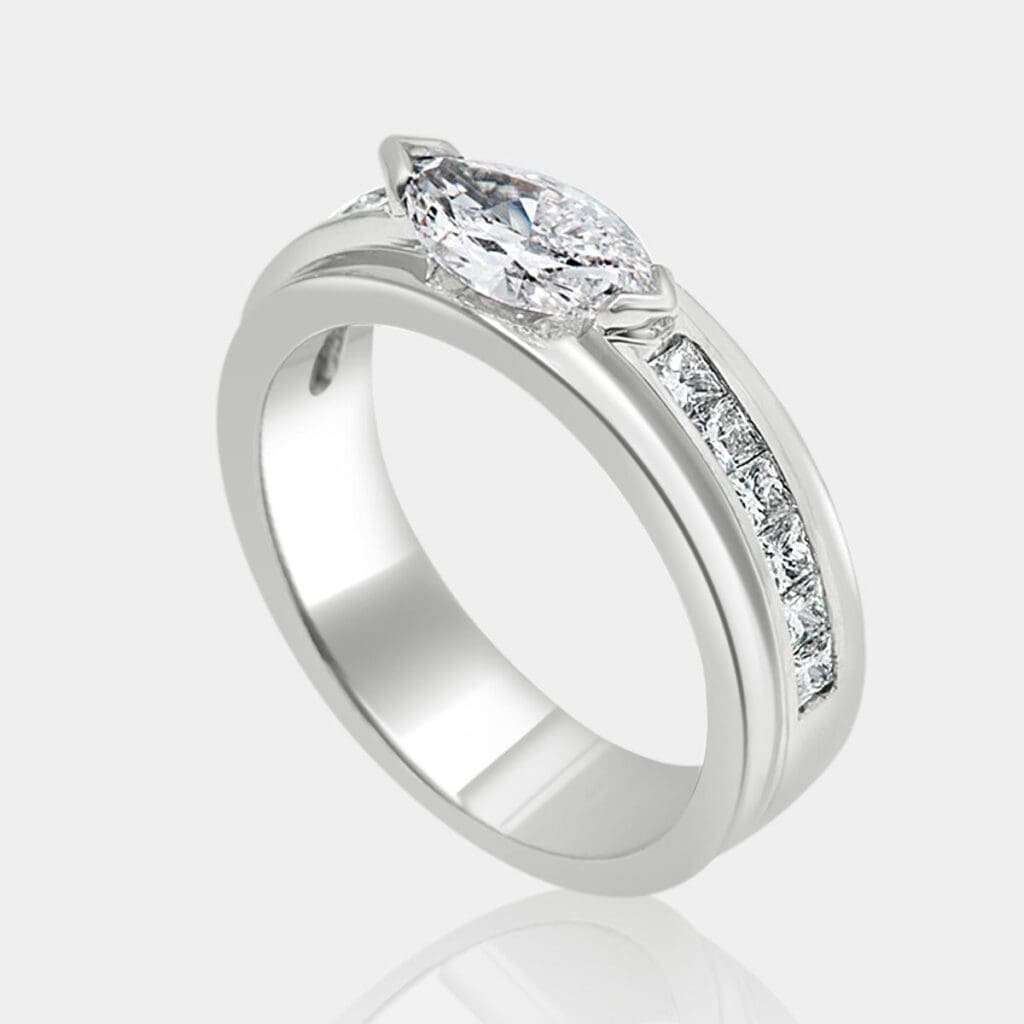 Handmade marquise diamond engagement ring with princess cut shoulder diamonds set in 18ct white gold.
