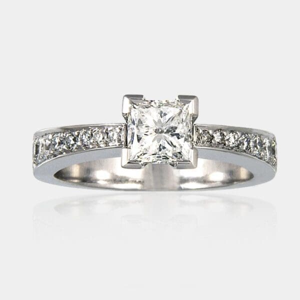 0.73 carat Princess cut diamond ring with shoulder diamonds.
