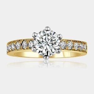 Round brilliant cut diamond engagement ring with shoulder diamonds and crown setting in 18ct white and yellow gold.