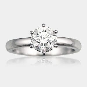 Handmade round brilliant cut solitaire diamond engagement ring with six claw seting in 18ct white gold.