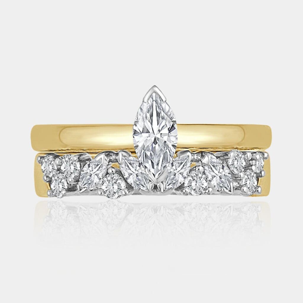Marquise and round brilliant cut diamond wedding ring in white and yellow gold, matching with a simple marquise diamond engagement ring.