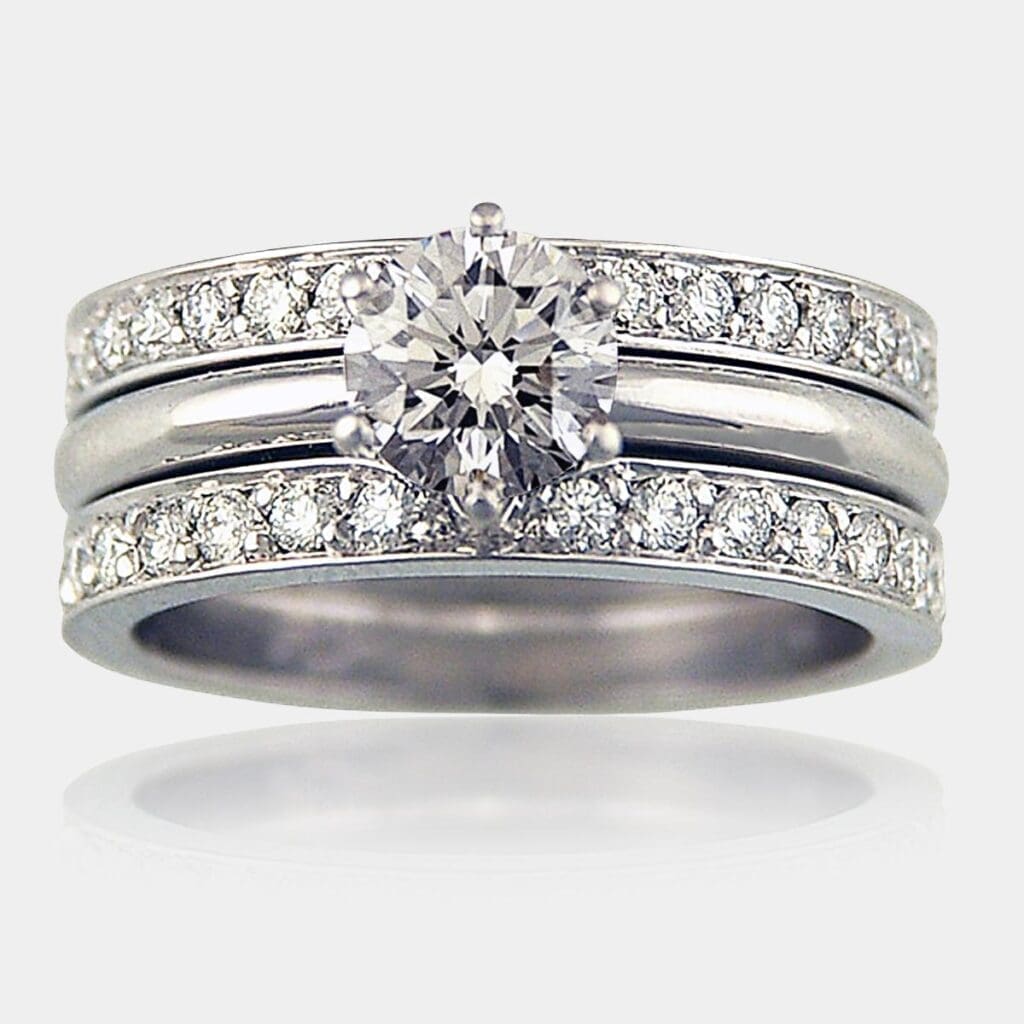 Round brilliant cut diamond engagement ring with matching wedding ring and eternity ring, both fully set with round diamonds.
