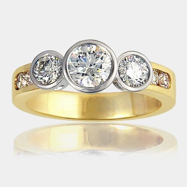 3 stone diamond ring totaling 2 carat, with channel set shoulder diamonds, set in 18ct white and yellow gold.