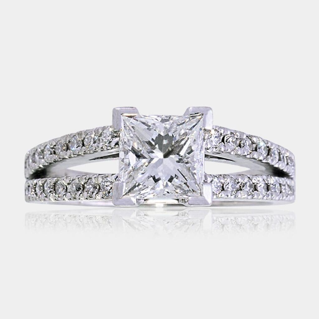 Handmade princess cut diamond engagement ring in 18ct white gold V-claw setting with double row of round brilliant cut diamonds in split shank.