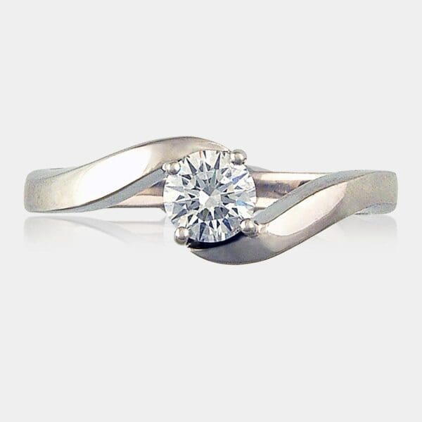 Round brilliant cut diamond in a cross over style ring.