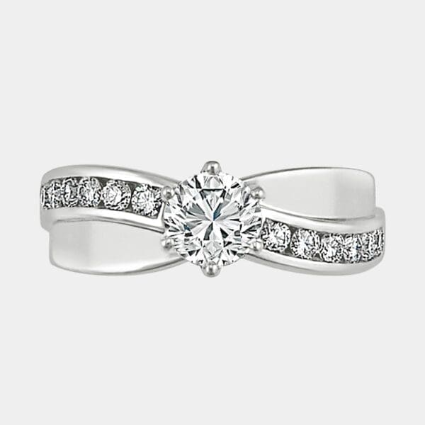Round brilliant cut diamond engagement ring with wave of channel set diamonds.