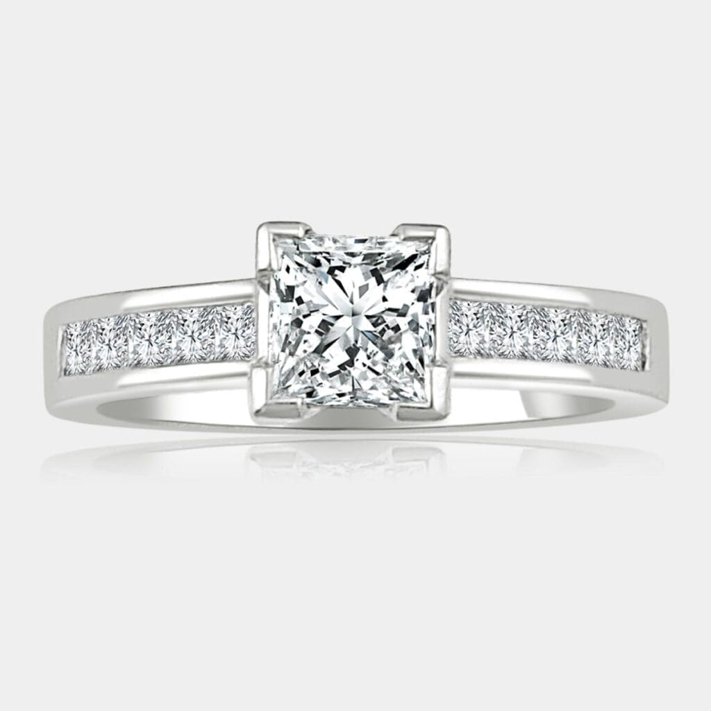 0.60 carat Princess cut diamond ring with princess cut shoulder diamonds set in 18ct white gold.
