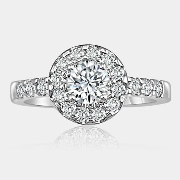 Handmade round brilliant cut diamond halo engagement ring in 18ct white gold with diamond shoulders.