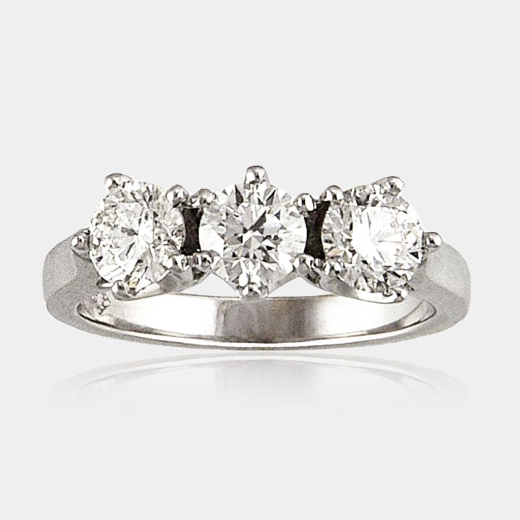 Three 3 stone ring in 18ct white gold featuring round brilliant cut diamonds in a row.