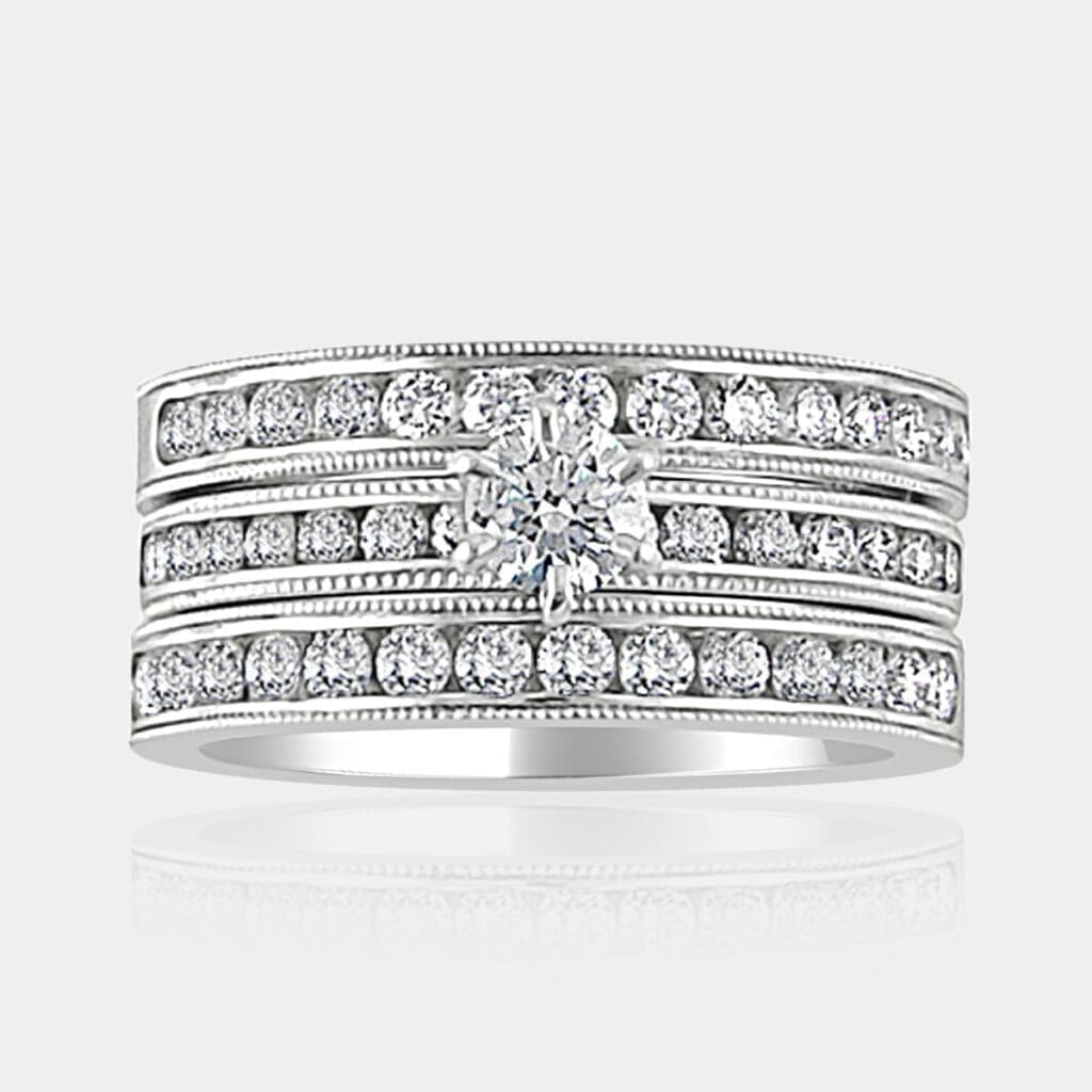 0.35 carat Round brilliant cut diamond ring with channel set shoulder diamonds and two matching diamond wedding bands, milgrain finish.